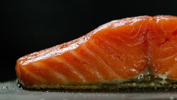 Seared Salmon on top of Induction Cooktop and Black Countertop.